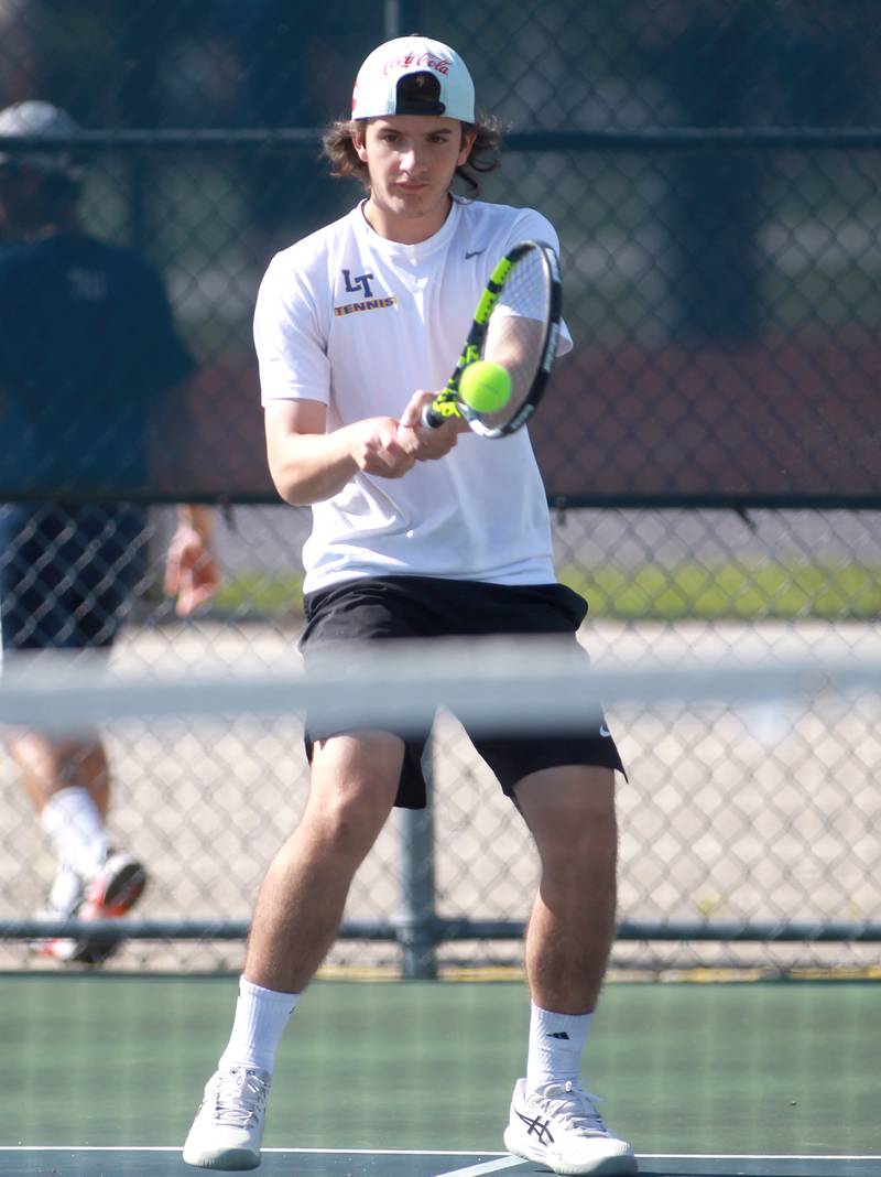Lyons Township’s Mason Mazzone returns the ball during a doubles match with partner Jack McLane (not pictured) in the state championship preliminaries at Buffalo Grove High School on Thursday, May 23, 2024.