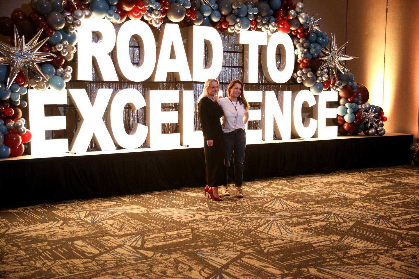 Ula Maka (left) and Beata Mueller of Encore Gallery pose for a photo during the 55th Annual Charlemagne Awards Dinner hosted by the St. Charles Chamber of Commerce at the Q Center in St. Charles on Friday, May 19, 2023.