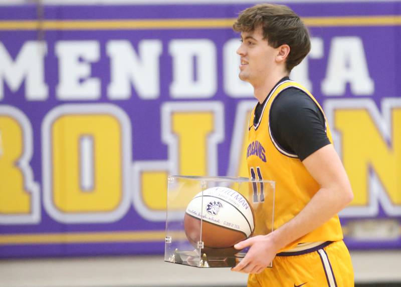Mendota's Aden Tilman holds his commemorative basketball after scoring his 1,000th career point on Tuesday, Feb. 3, 2026 at Mendota High School.