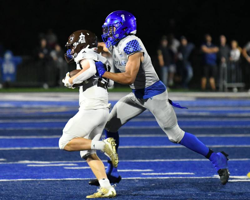 St. Francis’s Corlin Greenwell, right, takes down Joliet Catholic Academy Keegan Farnaus during the second quarter on Friday Sep. 22, 2023, at St. Francis High School in Wheaton.