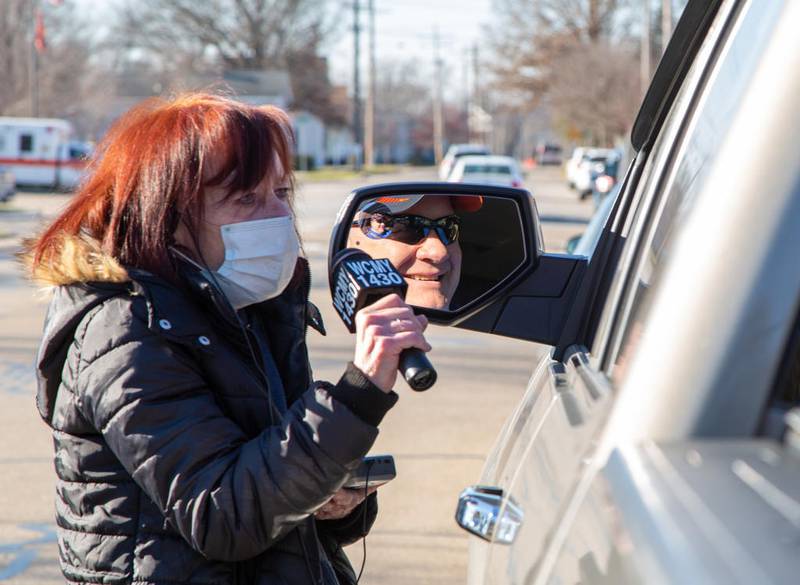 Maggie Frost, of WCMY, talks with Rick Cook of Nucor Tubular Products in Marseilles for a live remote Friday afternoon in front of the radio station in Ottawa during Freezin for a Reezin. The annual food drive was adjusted this year because of COVID-19 safety procedures. Instead of collecting non-perishable items, checks and cash were collected outside WCMY and Handy Foods to support the Community Food Basket of Ottawa.