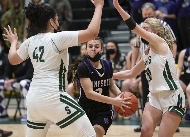 Hampshire's Ceili Ramirez moves through Crystal Lake South defenders Nicole Molgado and Hanna Massie during their game on Friday, January 14, 2022 at Crystal Lake South High School.