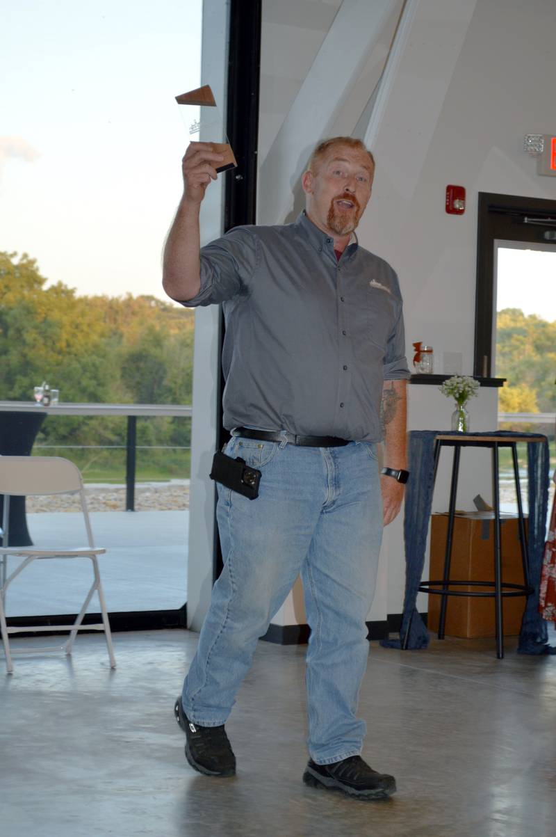 Rustic Ridge Axe Throwing manager Chris Chapman holds up the Oregon Area Chamber of Commerce's 2023 Welcome to the Chamber Award after thanking everyone for being so welcoming. The Chamber's annual awards dinner took place Thursday, Aug. 17, 2023, at River's Edge Experience in Oregon.