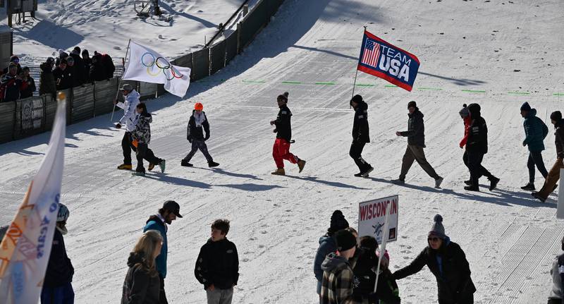 The Olympic flag crosses the landing area during the opening ceremony of the Norge Ski Jump 121st Annual Winter Tournament on Feb. 1, 2026 at the Norge Ski Club, 100 Ski Hill Road, Fox River Grove.