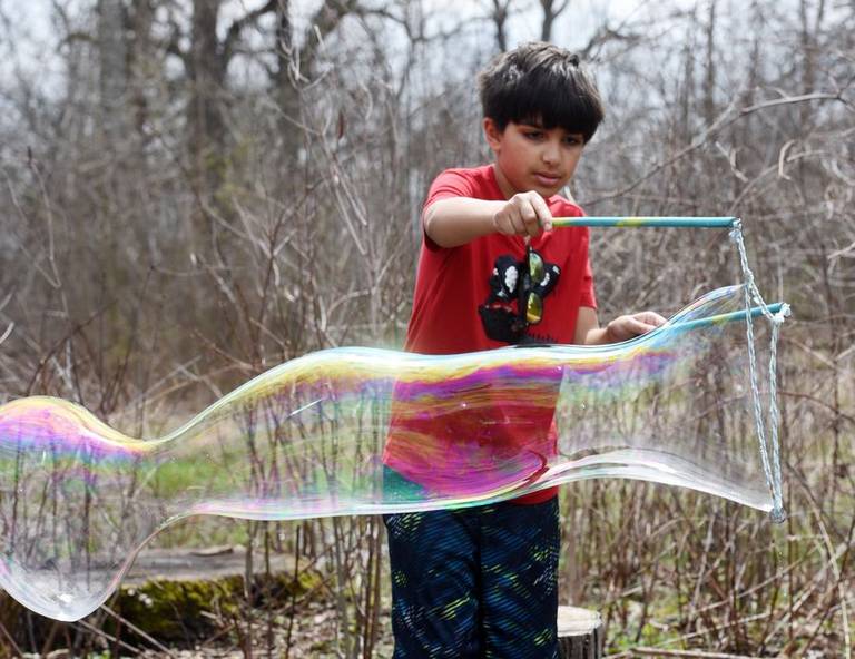 Amro Rajab, 8, of Hoffman Estates makes bubbles during the Cook County Forest Preserve Earth Day event Saturday, April 23, 2022, at the Crabtree Nature Center in Barrington Hills.