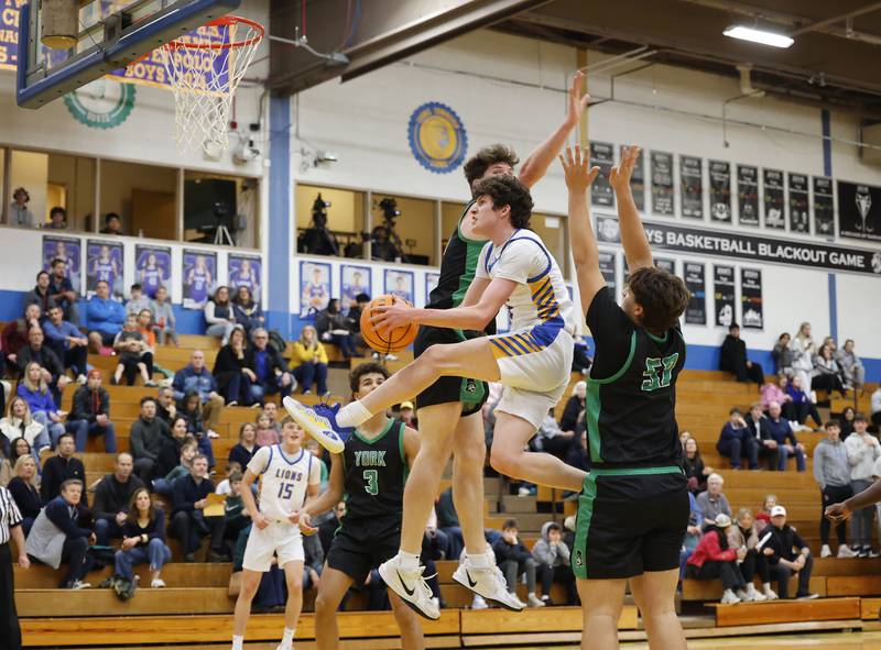 Lyons' Owen Carroll (5) splits the York defense during a varsity basketball game between York Community and Lyons Township high schools on Friday, Jan. 9, 2026 in La Grange.