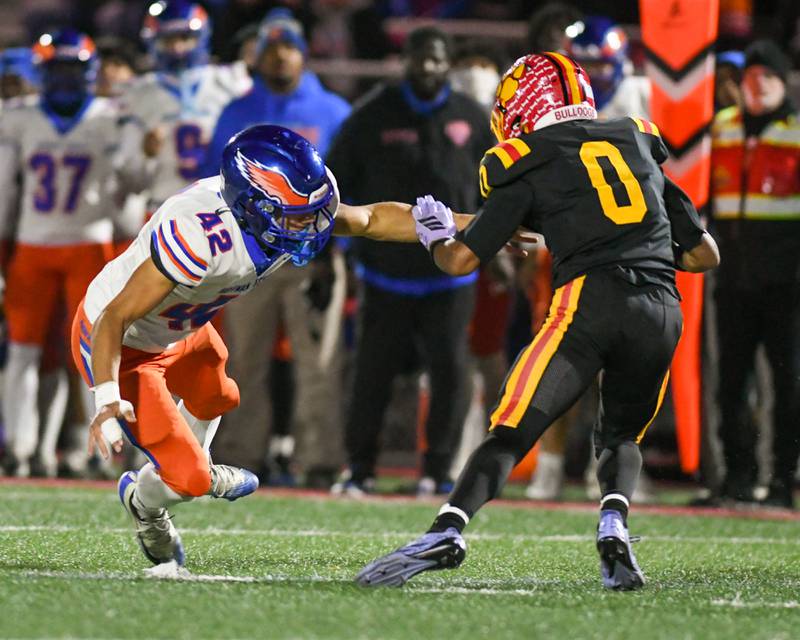 Hoffman Estates's Josh Classen (42) tries to tackle Batavia's Darin Ashiru (0) during the first round of playoffs on Friday Oct. 31, 2025, held at Batavia High School.