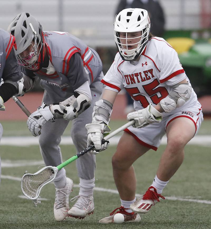 Huntley's Andrew Baumley, right battles with Palatine's Joseph Spizzirri during a boys lacrosse match Tuesday, May 3, 2022, between Huntley and Palatine at Huntley High School.