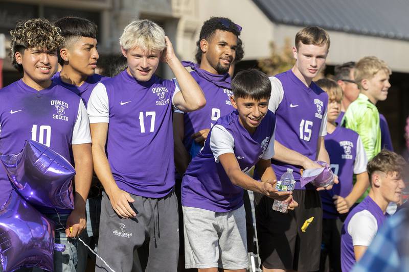 The Dixon soccer team throws candy Friday, Oct. 3, 2025, in the homecoming parade.