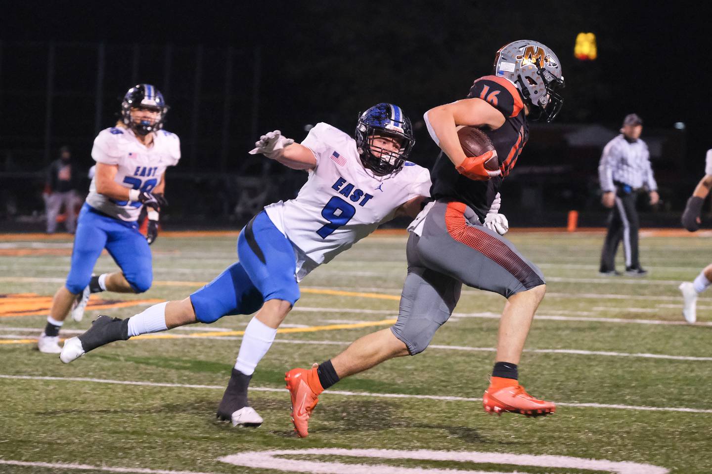Lincoln-Way East's Michael Cardilli brings down Minooka's Ethan Murphy for no gain in the Class 8A 2nd round playoffs in Minooka on Saturday, Nov. 6, 2021.