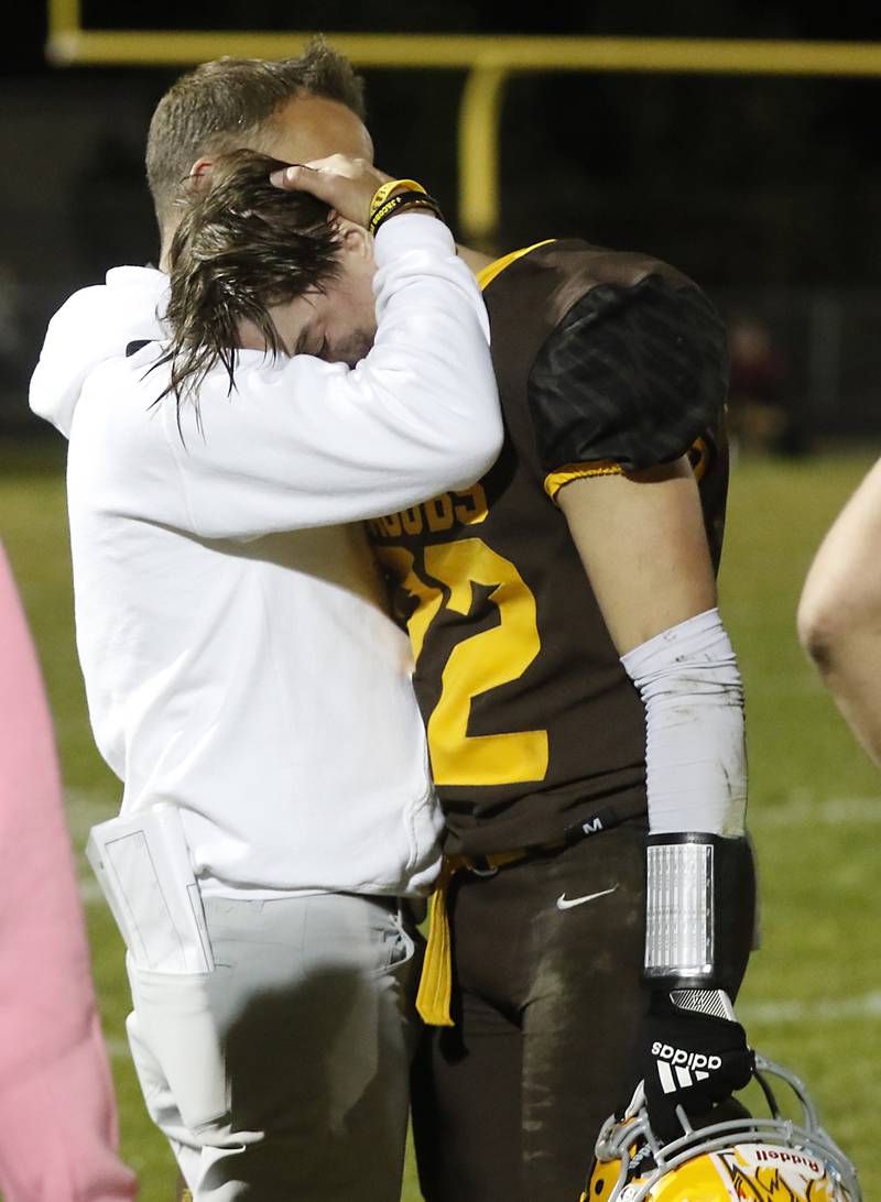Jacobs football coach Brian Zimmerman hugs Ashton Niehaus after Jacobs lost to Brother Rice in a IHSA Class 7A first round playoff football game Friday, Oct. 28, 2022, at Jacobs High School in Algonquin.