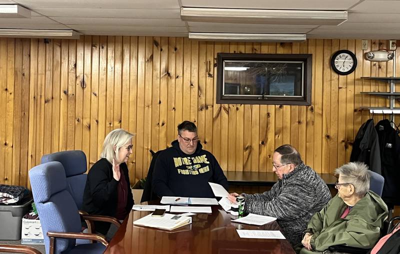 Kristine Dobbs (left) is sworn in as supervisor of Coloma Township Board of Trustees at its special meeting Tuesday, Feb. 18, 2025.