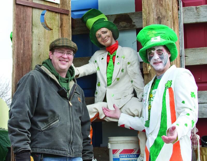 2013 File: Luke Dixon (left) shows Mike Lahey how he inspired the Cahill’s latest parade float.