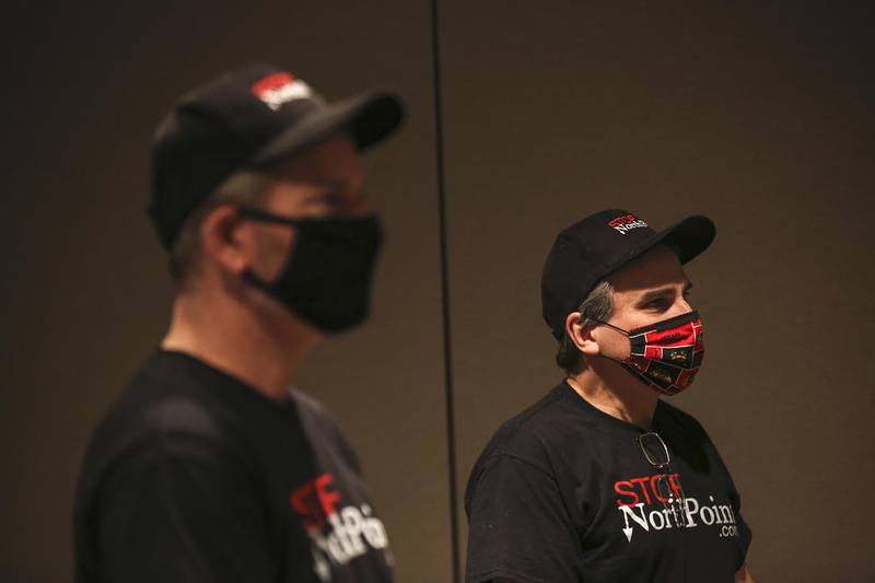 Ron Adamski (left) and John Kieken of Stop NorthPoint watch the hearing from a monitor on Thursday, Dec. 10, 2020, at Joliet City Hall in Joliet