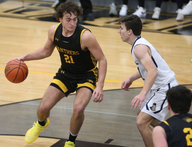 Putnam County's Orlando Harris works his way in the lane as Marquette's Orlando Harris defends during the Tri-County Conference Tournament on Tuesday, Jan. 23, 2024 at Putnam County High School.