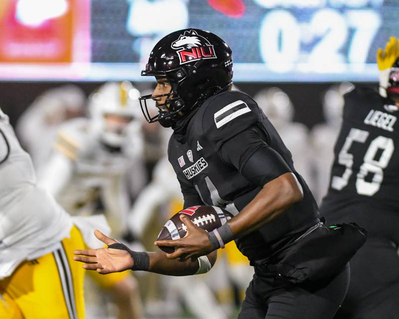Northern Illinois University's quarterback Jalen Macon (14) runs the ball during the game against Western Michigan on Tuesday Nov. 18, 2025, held at Huskie Stadium in DeKalb.