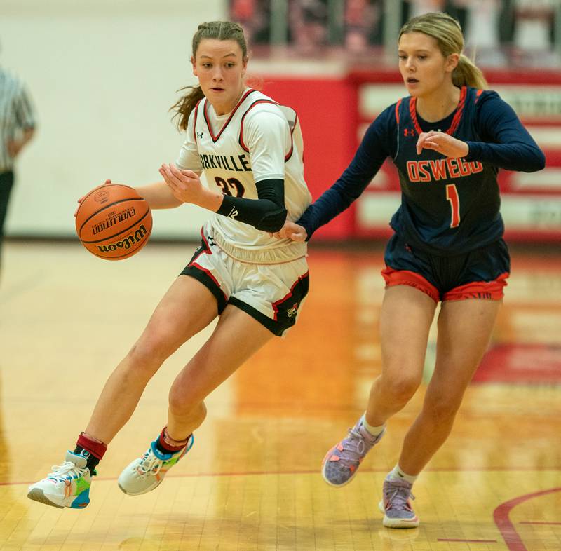 Yorkville's Elaine Gussman (32) drives to the hoop against Oswego’s Mykenna Kaye (1) during the 13th annual Hoops 4 Hope Communities vs. Cancer basketball event at Yorkville High School on Saturday, Jan 28, 2023.