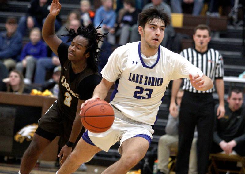 Jacobs’ Emaan Thomas, left, in Hinkle Holiday Classic boys basketball tournament game action at Jacobs High School Tuesday.