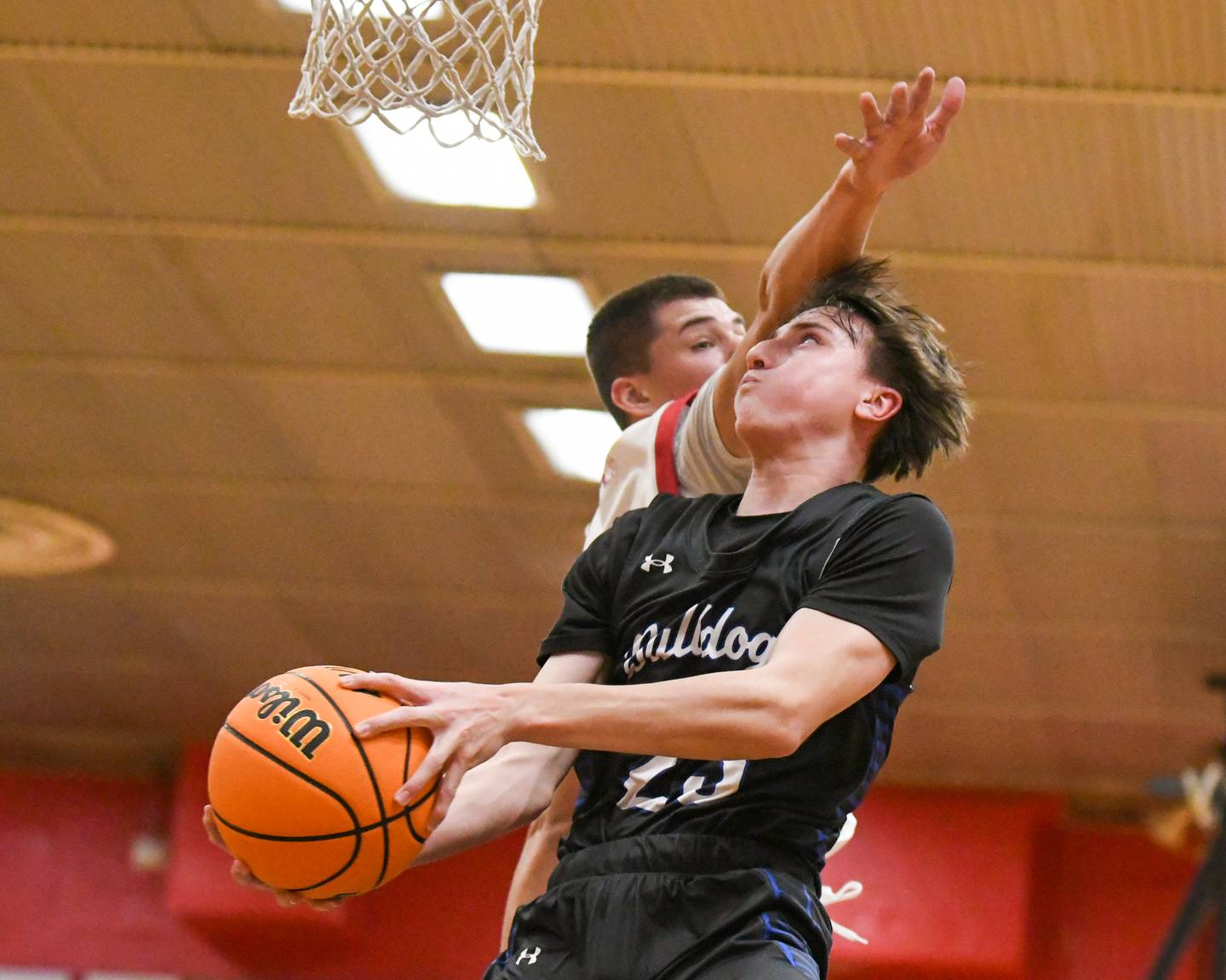 Riverside Brookfield's Noah Van Tholen (23) goes up for a shot during the game while being defended by Glenbard East's Jacob Marynowski (15) on Friday Dec. 19, 2025, held at Glenbard East High School.