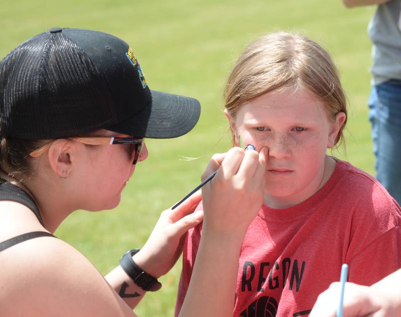Ashyn Whaley of Dixon paints the face of Grey O'Rourke during the family-themed celebration at the Oregon VFW following the traditional Memorial Day service in Oregon on Monday, May 26, 2025.