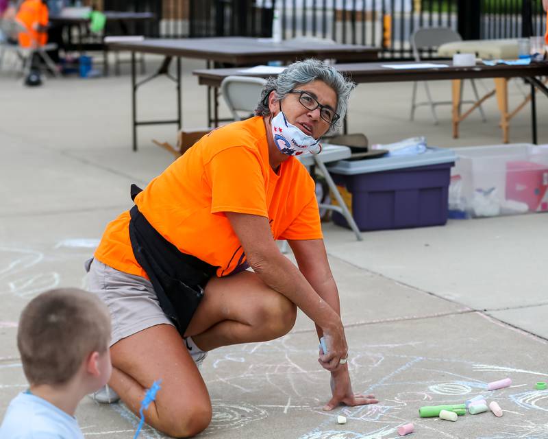 Volunteer Susie Niemiec instructs the kids at the community festival and running fundraiser for mental health awareness and suicide prevention in honor of Ben Silver.  July 23, 2022.