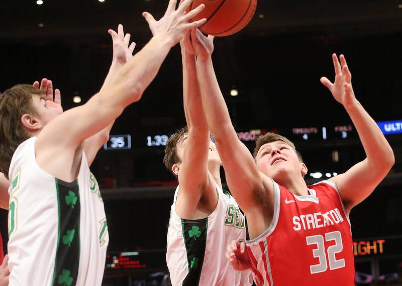 Streator's Andrew Vogel grabs a rebound over Seneca's Sam Kleich and teammate Brady Sheedy during a game against Seneca on Tuesday, Dec. 21, 2023 at the United Center in Chicago.