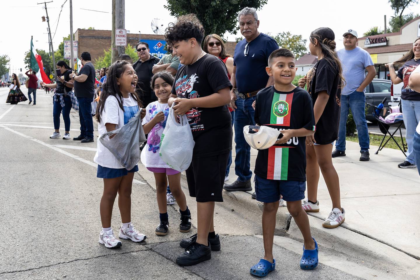 Natalie, Camila, Christian, and Manny Cerrillo smile after collecting candy during the City of Joliet Fiestas Patrias Mexican Independence Day Parade on Sept. 13, 2025.