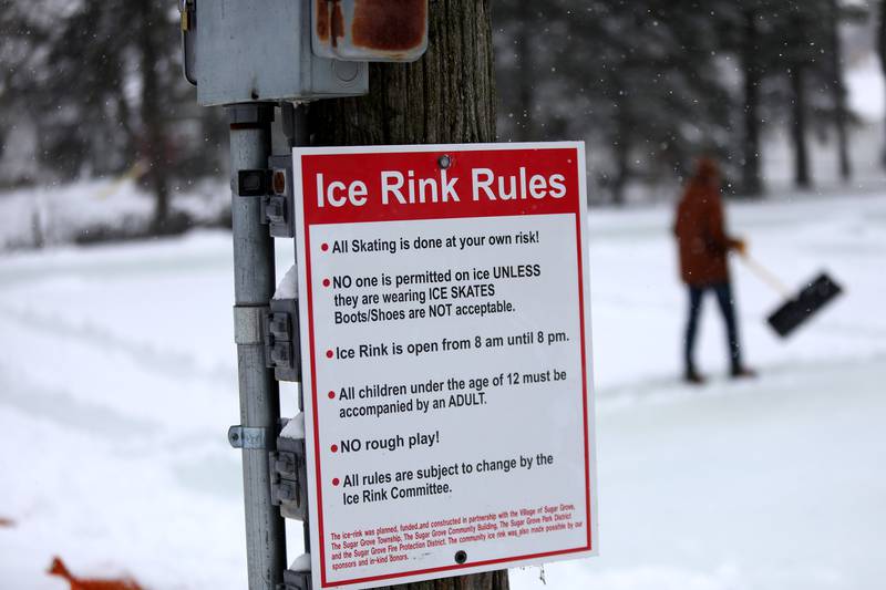 Sugar Grove Park District employees clear snow from the ice rink on Friday, Jan. 10, 2025 behind the Sugar Grove Township Community Building. The rink is frozen and ready for skaters.