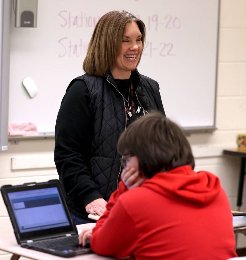 Jenni Smith, an eighth grade math teacher at Huntley Middle School, smiles Wednesday, March 19, 2025, as she teachers her class at the school in DeKalb.