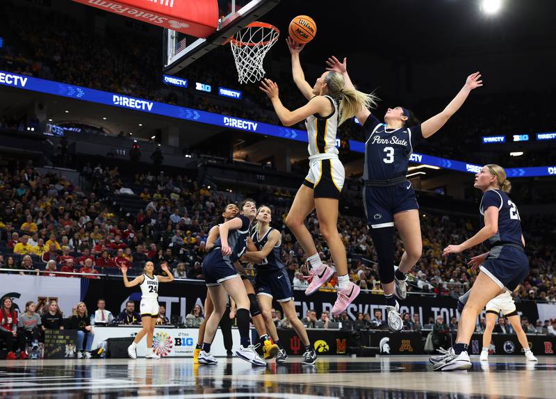 Iowa Hawkeyes guard Kylie Feuerbach (4) goes to the hoop against Penn State in the quarterfinals of the Big Ten Women’s Basketball Tournament on Friday, March 8, 2024 at the Target Center in Minneapolis. (Brian Ray/hawkeyesports.com)