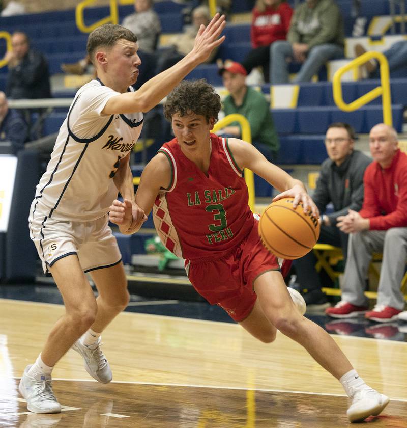 Lasalle-Peru’s Mikey Hartman drives past Sterling’s Bryce Hartman Tuesday, Jan. 7, 2025, at Sterling High School.