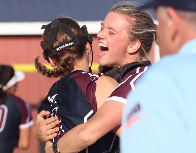Marengo’s Kylee Jensen, right, embraces Jozsa Christiansen as the Indians celebrate a win over Aurora Central Catholic in IHSA Class 2A Regional Title Game action softball at Marengo High School in Marengo on Friday, May 23, 2025.