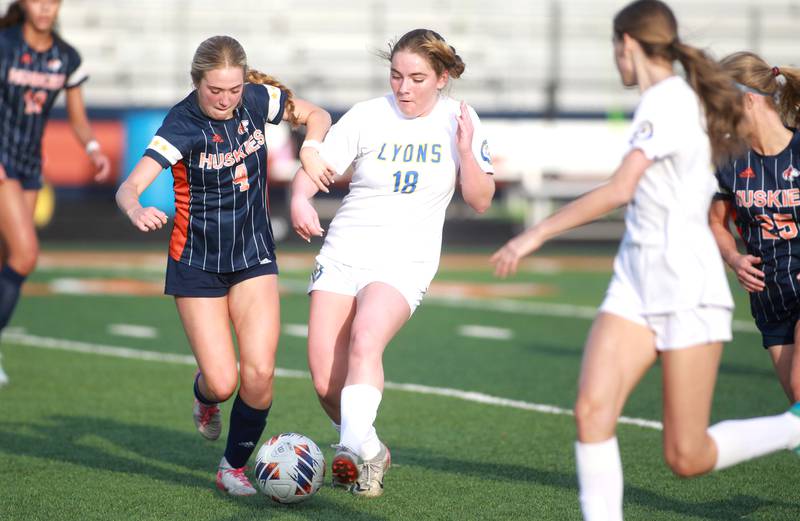 Naperville North's Lily Radek and Lyons Township's Claire Parkhill go after the ball during a game on Wednesday, April 16, 2025 in Naperville.