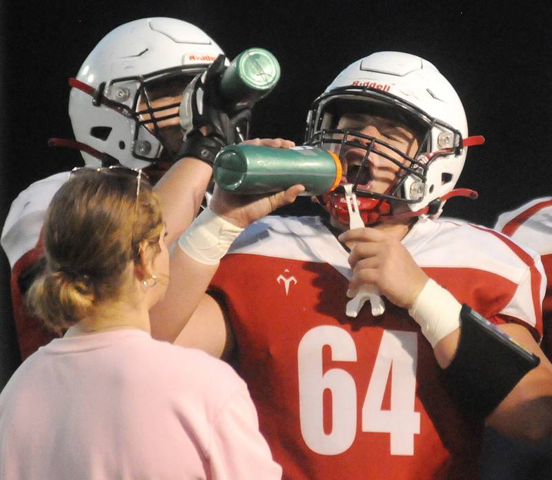 Streator's Luke Gebhardt grabs a drink of water during a timeout in their game against East Peoria at Deiken Stadium on Friday, Aug. 25, 2023.