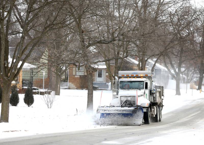 A plow truck travels on Prairie Street in Downers Grove as temperatures dip below zero on Friday, Dec. 23, 2022.