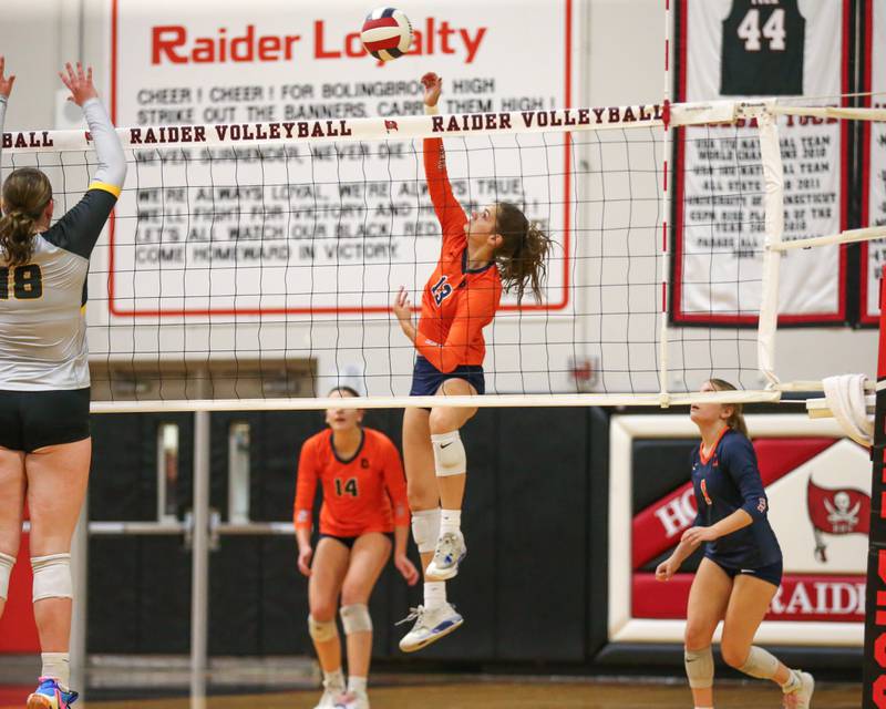 Oswego's Sidney Hamaker (13) spikes the ball during Class 4A Bolingbrook Sectional semifinal match between Joliet West at Oswego.  Nov 5, 2024  in Bolingbrook.