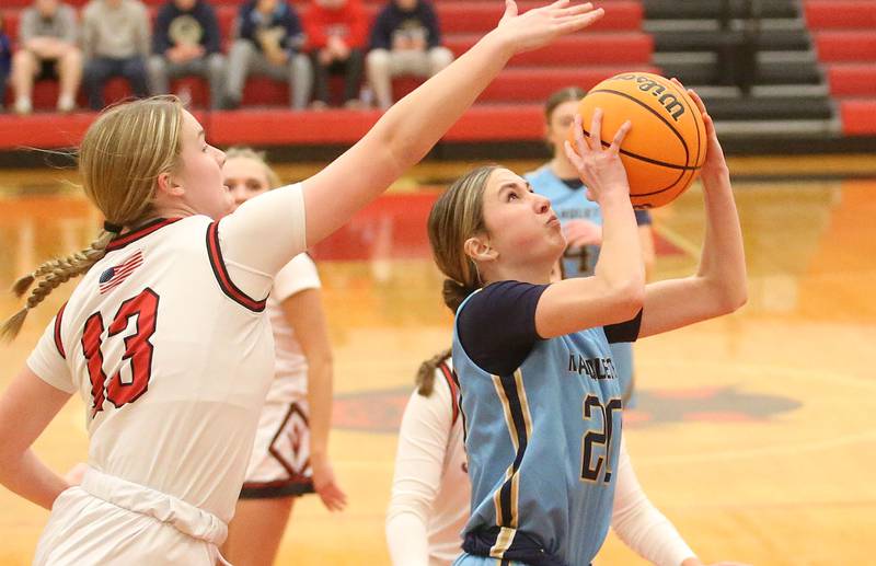 Marquette's Kaitlyn Davis eyes the hoop after getting by Hall's Leah Pelka in the lane on Thursday, Feb. 13, 2025 at Hall High School.
