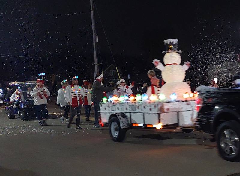 The Let it Snow float pumped artificial snow Saturday, Dec. 2, 2023, into the Lighted Christmas Parade in Peru.