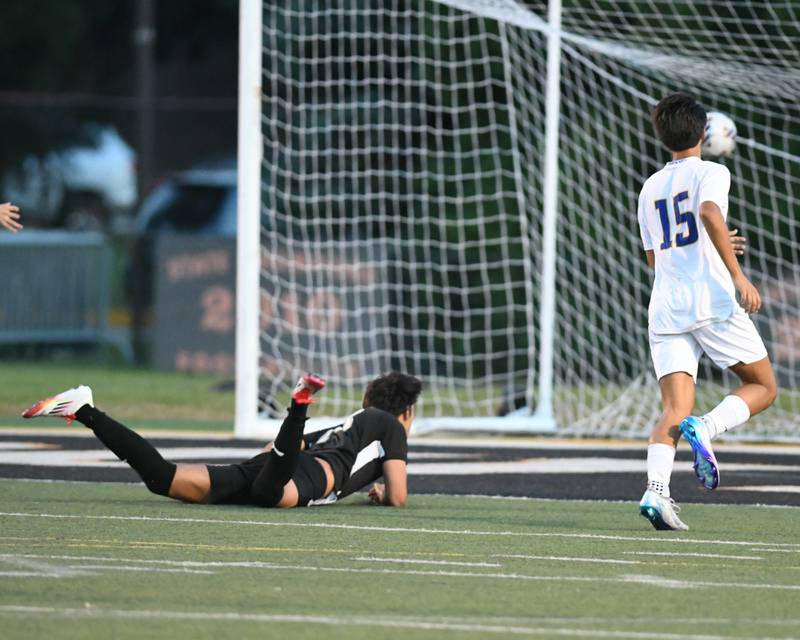 Wheaton Warrenville South's Joaqujin Martinez, left, watches the ball go in for a goal after tripping over Wheaton North’s goalie during the game on Thursday Sept. 11, 2025, held at Wheaton Warrenville South.