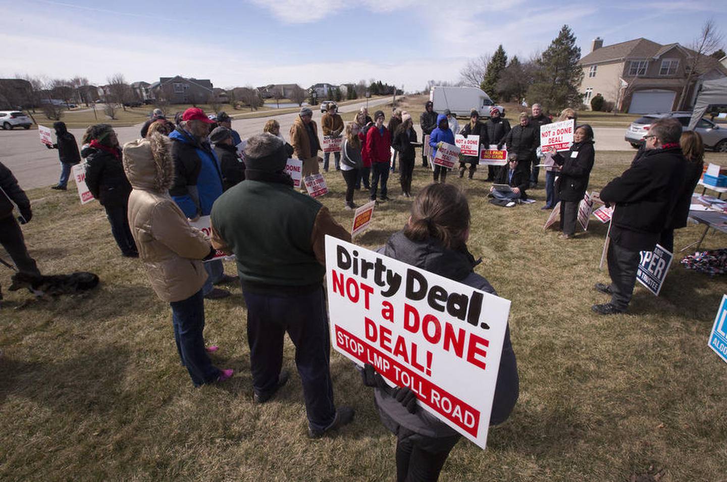 More than 50 concerned citizens gather to talk as they protest the expansion of Longmeadow Parkway and toll bridge on Saturday, March 11, 2017, in Algonquin.