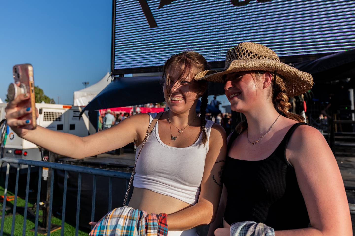 Wilmington residents Channing Sexton and Meghan Fisher take a selfie at Busey Bank Field at Joliet Memorial Stadium during Taste of Joliet on June 21, 2025.