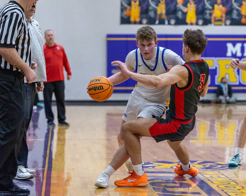 Johnsburg's Jayce Schmitt (30) dribbles ball into a falling Preston Morel (3) of Aurora Christian during the Class 2A Boys Sectional Basketball tournament game on Wednesday, March 4, 2026 at Mendota High School. Officials called a blocking foul against Morel.