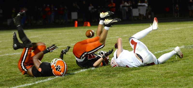 Two Byron defenders break up a pass to Oregon's Ethan Peeling (right) on Friday, Sept. 12, 2025 at Everett Stine Stadium in Byron.