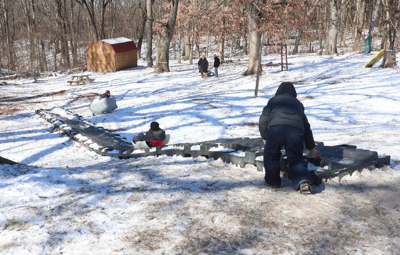 Kids sled down a toboggan run during the Lowaneu Cub Scout Yukon on Saturday, Jan. 31, 2026 at Hall Township Echo Bluff Park in Spring Valley.