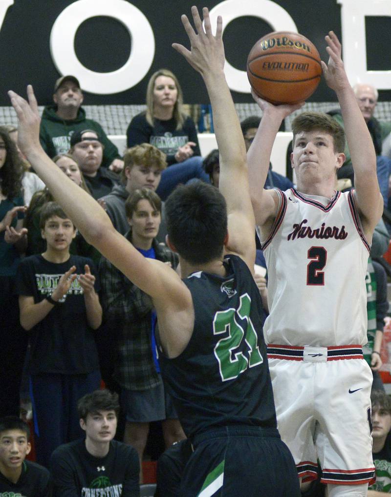 Woodland’s Jonathan Moore (2) shoots over the block attempt of Cornerstone Christian’s Josh Kalmes (21) on Monday during the first period at Woodland's Warrior Dome in rural Streator.