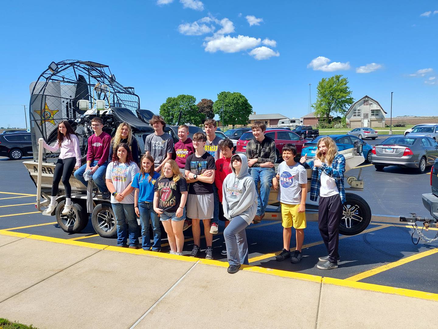 Eighth graders in the Illinois Postsecondary and Career Expectations program at Grand Ridge Grade School pose in front of Illinois Department of Natural Resources Conservation Police Officer Kyle Behrens on Friday, May 3, 2024, after he spoke to them about his career.