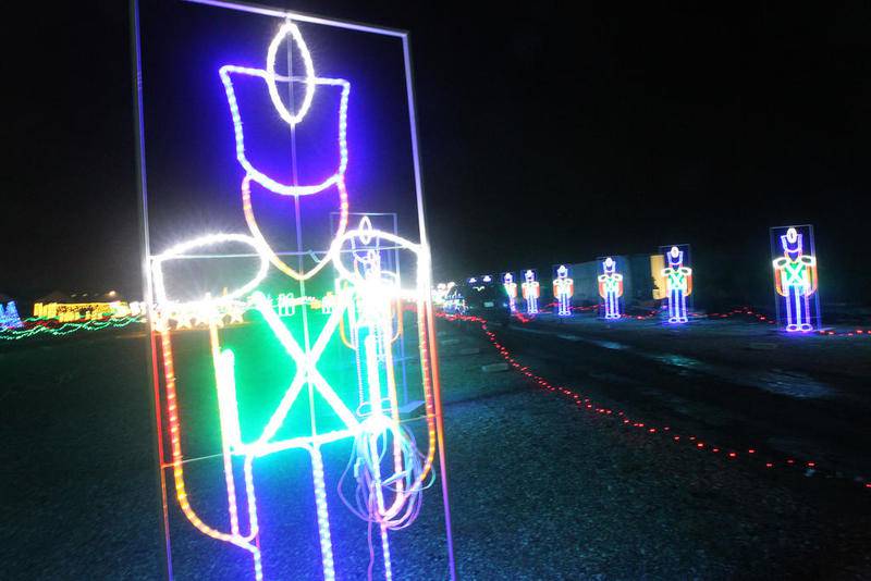 A car goes past a row of toy soldiers lit up at night Dec. 21 during the Santa’s Rock n Lights drive through Christmas light show at the Lake County Fairgrounds in Grayslake. Open every night through Dec. 31.