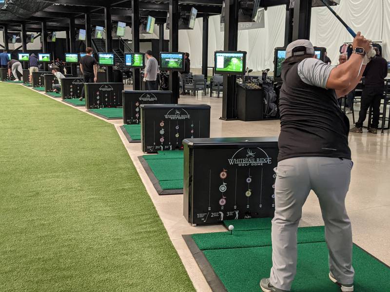 Jorge Cherriz was practicing his golf swing during the Nov. 1 grand reopening of the Whitetail Ridge Golf Dome in Oswego. The Oswego Area Chamber of Commerce hosted the event.