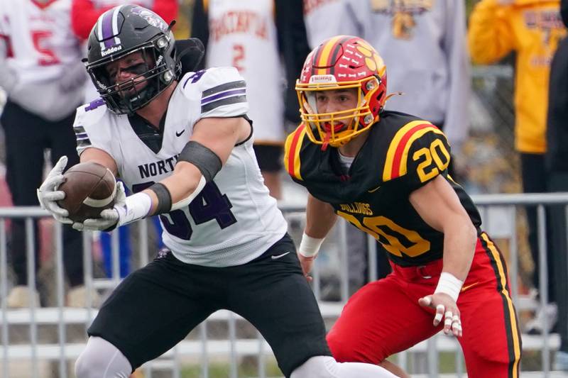 Downers Grove North's Jake Gregorio (34) catches a pass against Batavia’s Chase Osborne (20) during a class 7A quarterfinal playoff football game at Batavia High School on Saturday, Nov. 16, 2024.