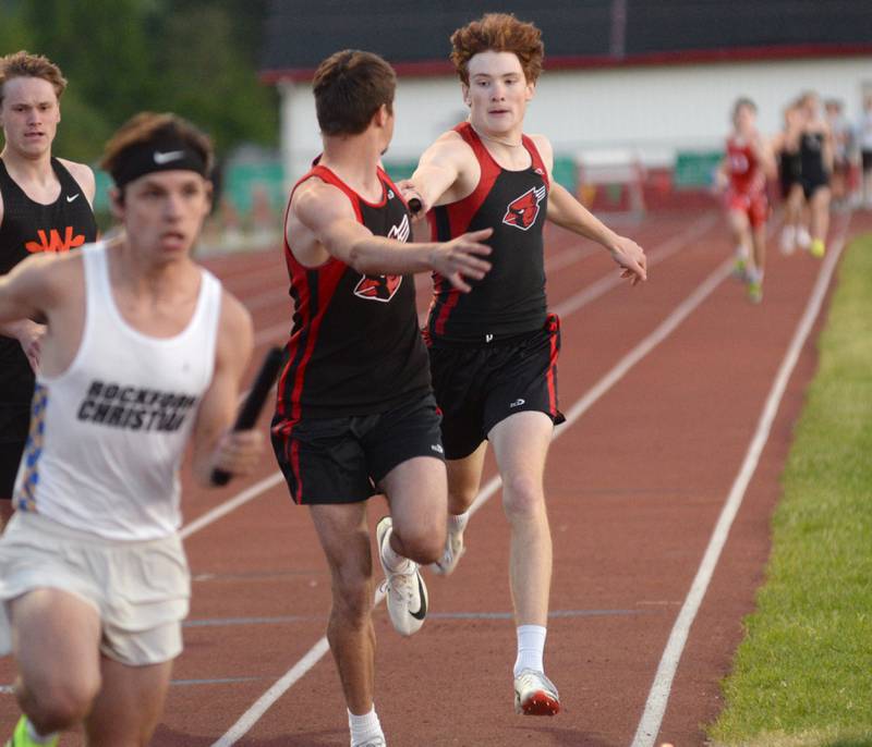 Forreston's Eli Ferris hands the baton to Noah Dewey in the 4x400 relay at the 1A Oregon Sectional at Landers-Loomis Field on Friday, May 23, 2025. The Cardinals finished second in the race and advanced to the state meet at Eastern Illinois University on Thursday, May 29.